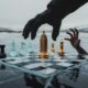 Prompt: 16:9, a conceptual image of a chessboard set on a frozen landscape. The pieces are stylized representations of government buildings and natural resources. A large, gloved hand from above is strategically moving a piece in Alberta, while a smaller, desperate hand tries to block the move. The colors are muted—grey, ice blue, and metallic gold. Sharp focus, dramatic lighting, suspenseful and professional editorial design.