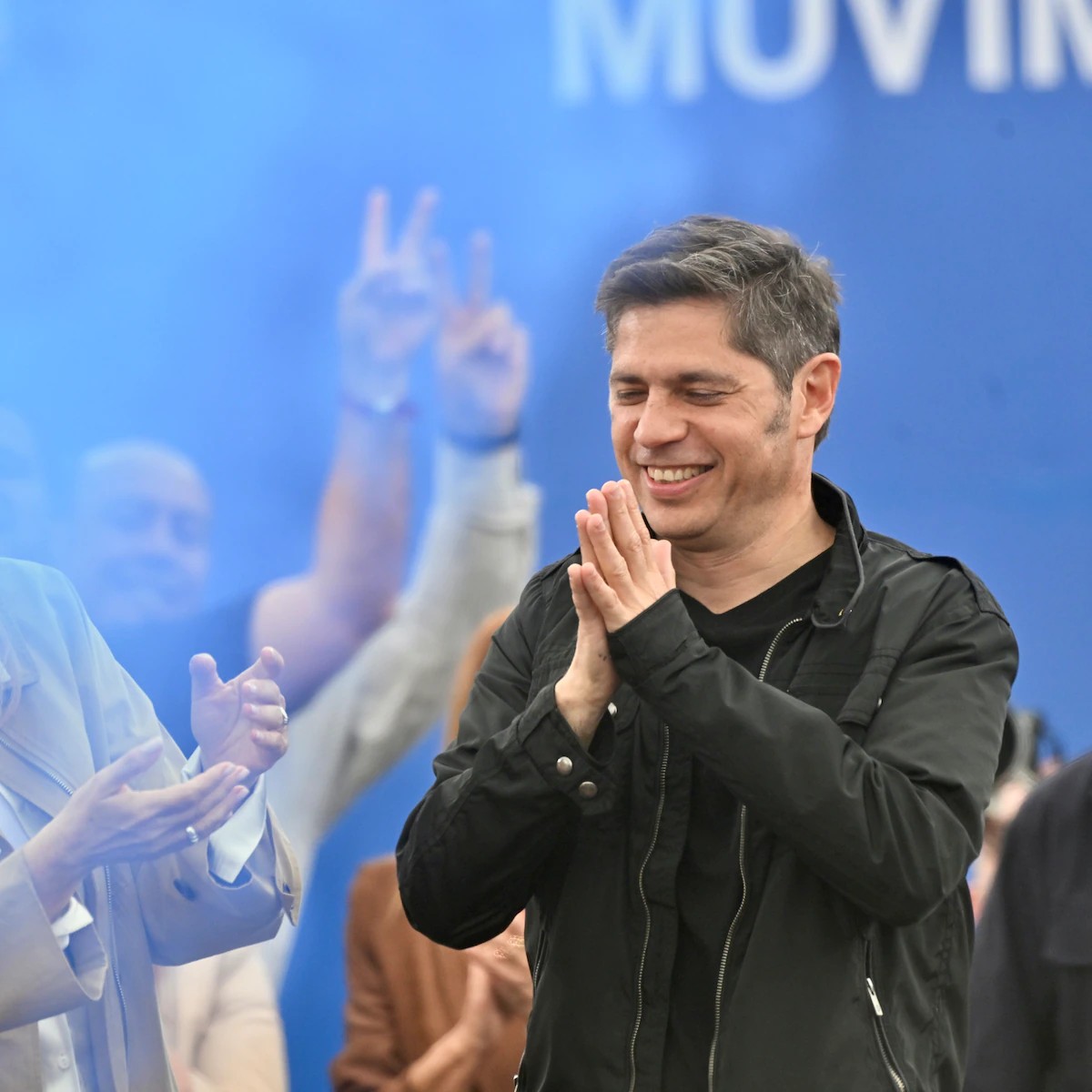 Axel Kicillof aplaude junto a militantes en un acto